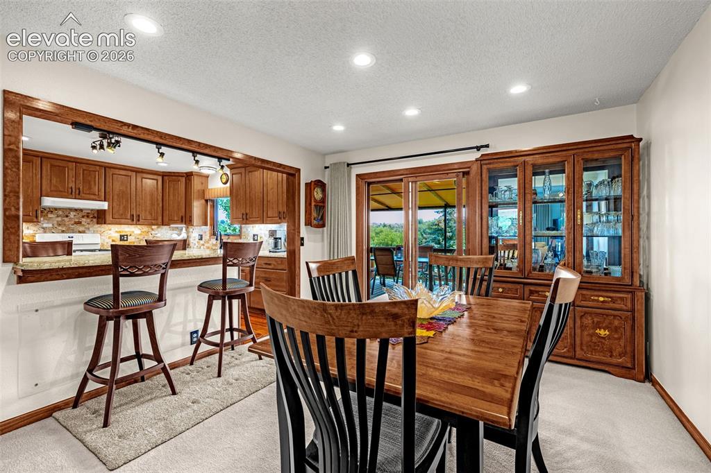 Image 9 of 42: Formal dining area adjoining kitchen with fantastic breakfast bar