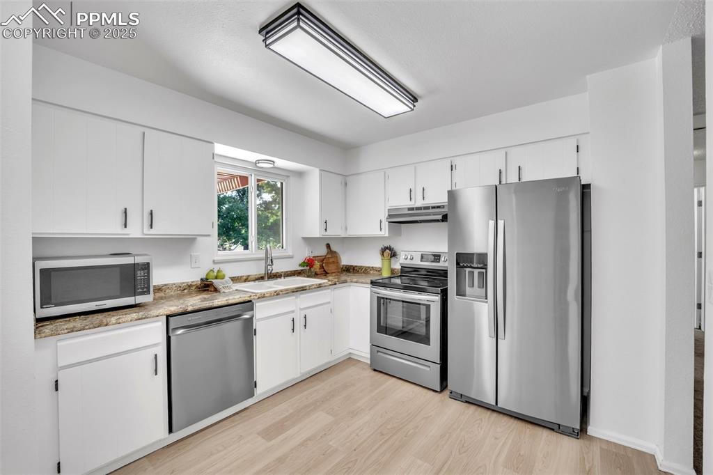 Image 12 of 34: Kitchen with appliances with stainless steel finishes