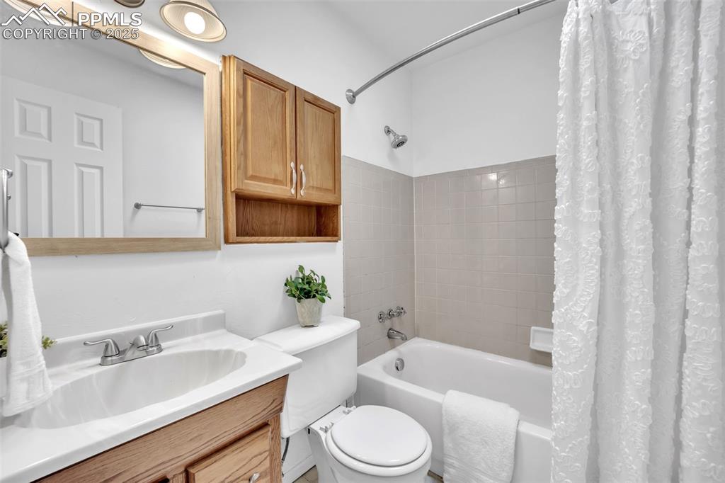Image 14 of 34: Bathroom featuring shower / tub combo and vanity