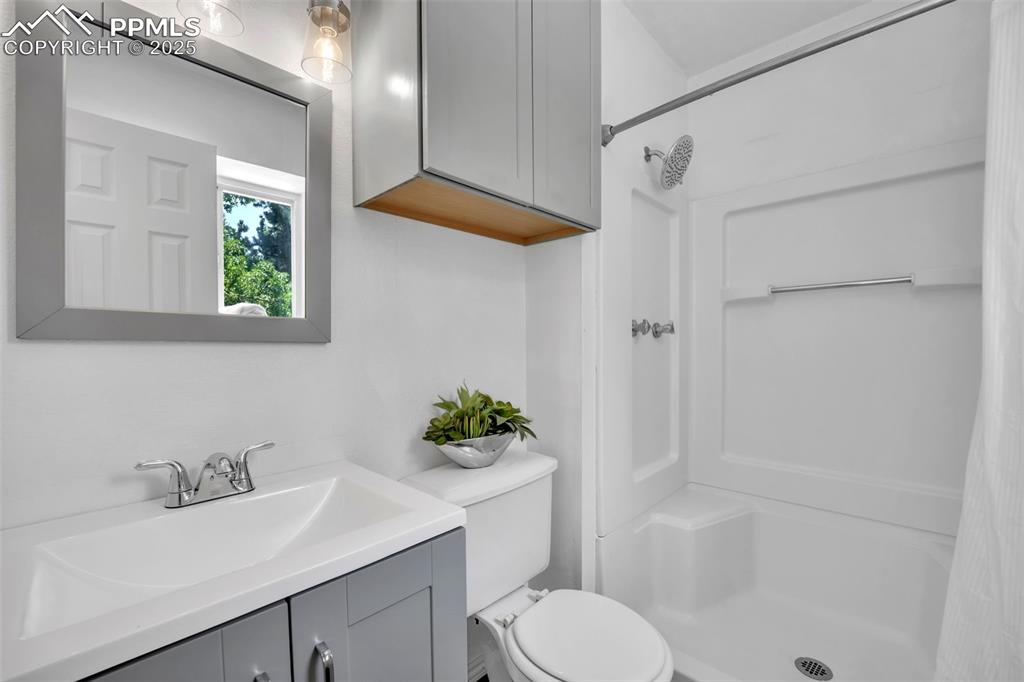 Image 19 of 34: Bathroom featuring vanity and a shower stall