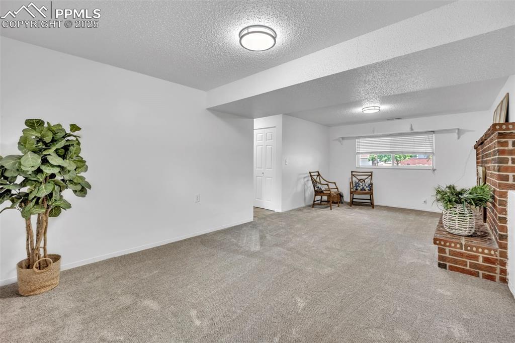 Image 25 of 34: Sitting room with carpet flooring and a textured ceiling