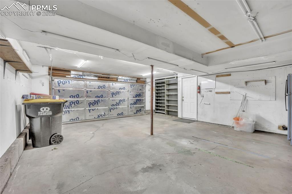 Image 26 of 34: Basement with freestanding refrigerator