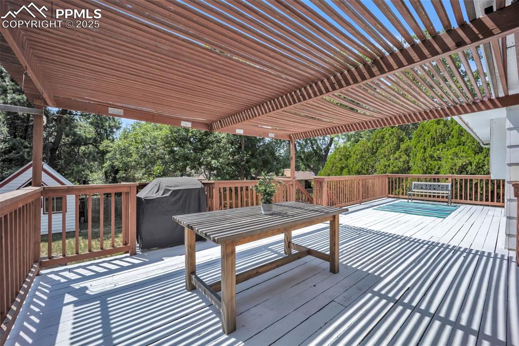 Image 27 of 34: Large back deck- 1/2 shaded, 1/2 not