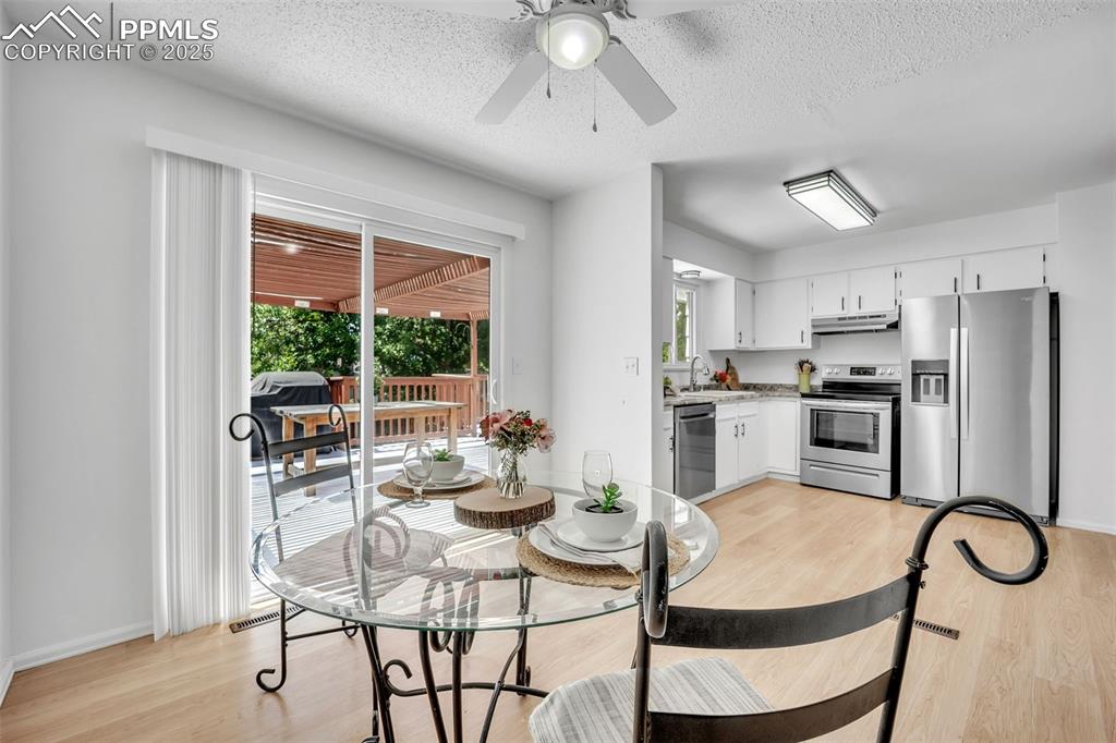 Image 4 of 34: Dining Area and kitchen with stainless steel appliances.