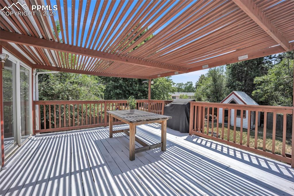 Image 8 of 34: Large Back deck is partially shaded.