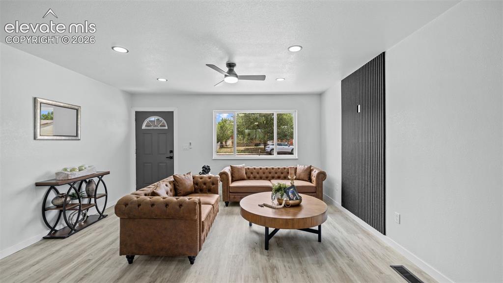 Image 14 of 31: Recessed lighting, wood-finish flooring, ceiling fan, and a prominent windo