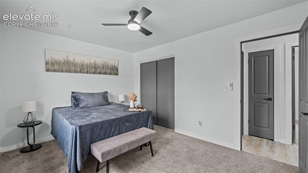 Image 18 of 31: Recessed lighting, ceiling fan, grey paneled doors, light grey walls, and c