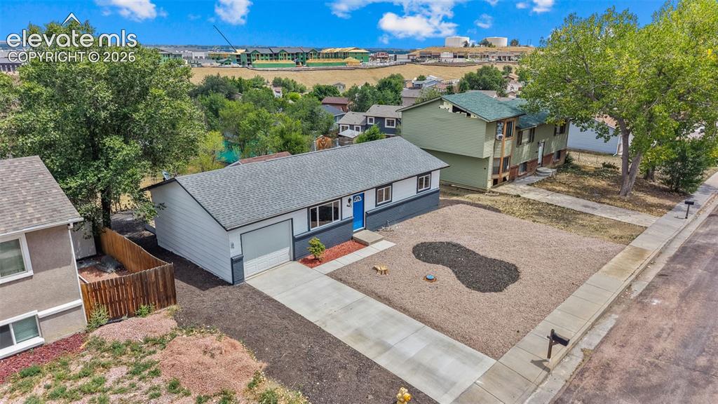 Image 25 of 31: Single-story residence featuring a concrete driveway, attached garage, and 