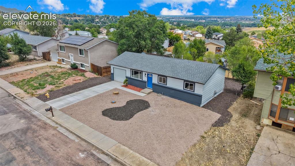 Image 26 of 31: Single-story residence featuring a gray asphalt shingle roof, light-colored
