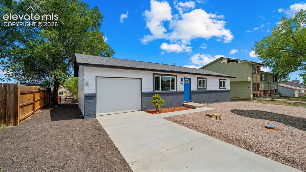 Image 3 of 31: Exterior featuring a blue front door, attached garage, and a concrete drive