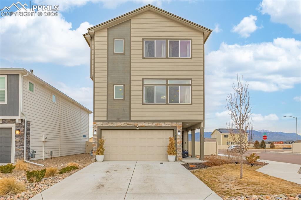 Image 1 of 33: Front of House with 2 Car Garage and mountain view in the horizon