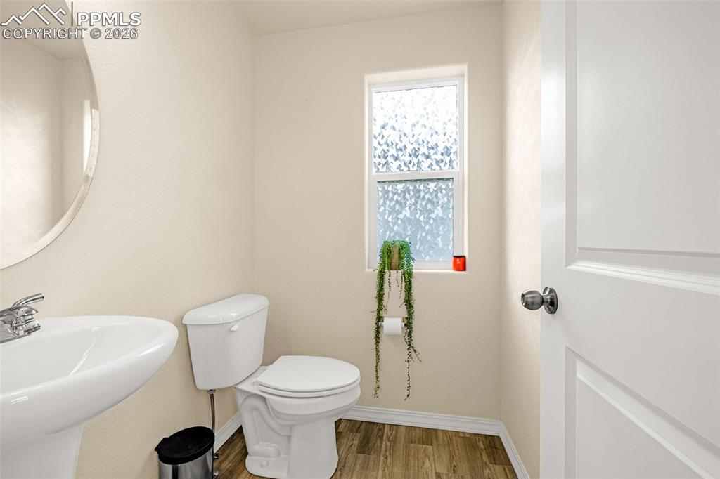 Image 15 of 33: half bath on main floor by the stairs