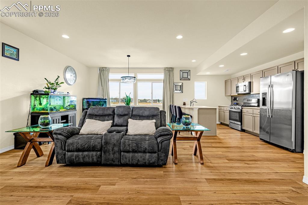 Image 5 of 33: going upstairs to the Main Floor entering the Family Room