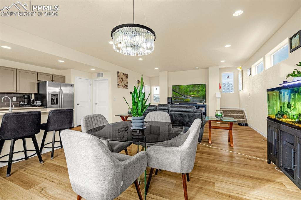 Image 8 of 33: Open Dining area Seating looking into the family room and kitchen