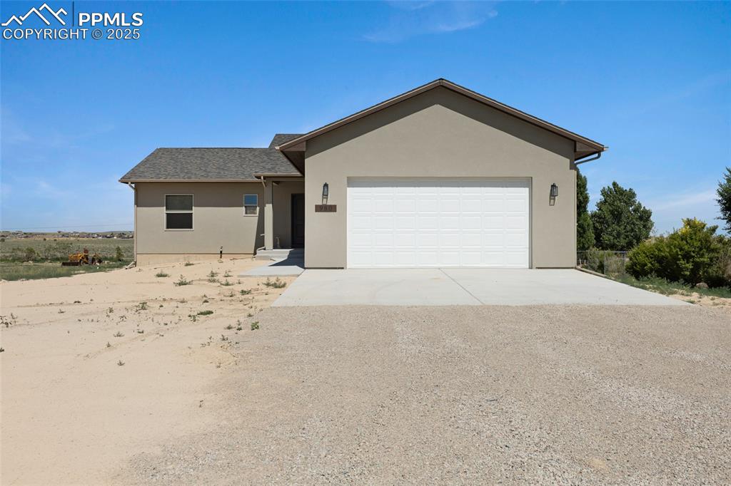 Image 1 of 41: Ranch-style house with driveway, stucco siding, an attached garage, and a s