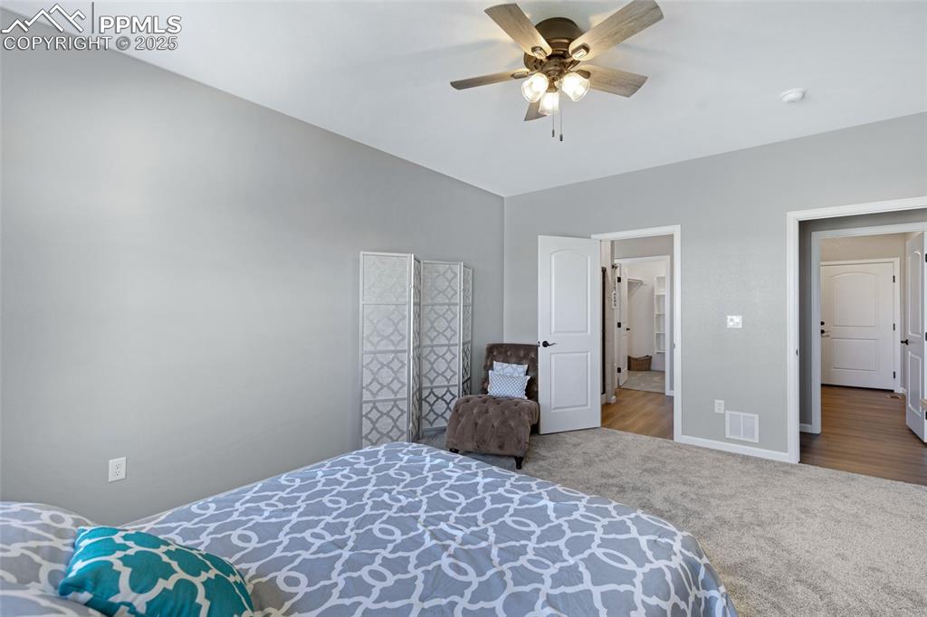 Image 15 of 41: Carpeted bedroom with ceiling fan and baseboards