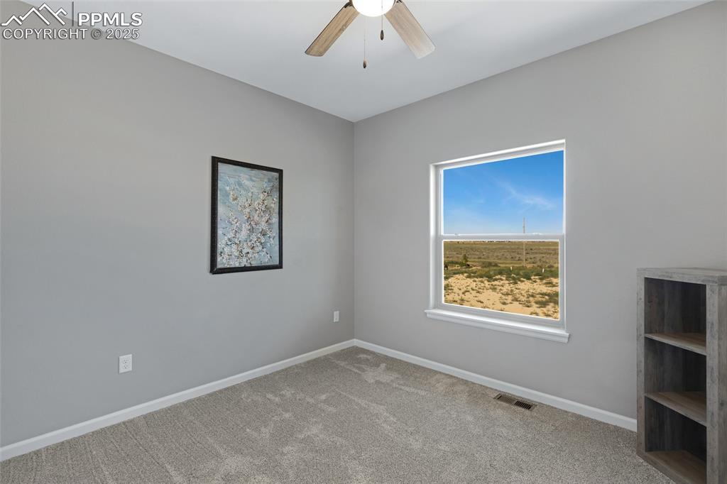 Image 21 of 41: Spare room with carpet flooring and ceiling fan