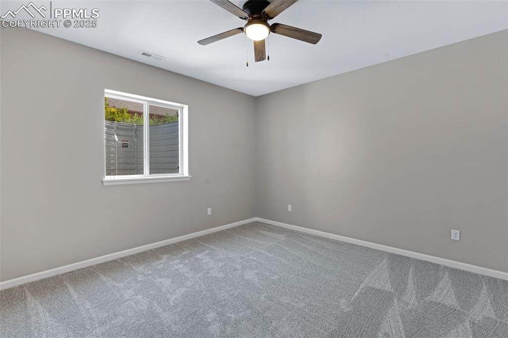 Image 24 of 41: Spare room with carpet floors and a ceiling fan
