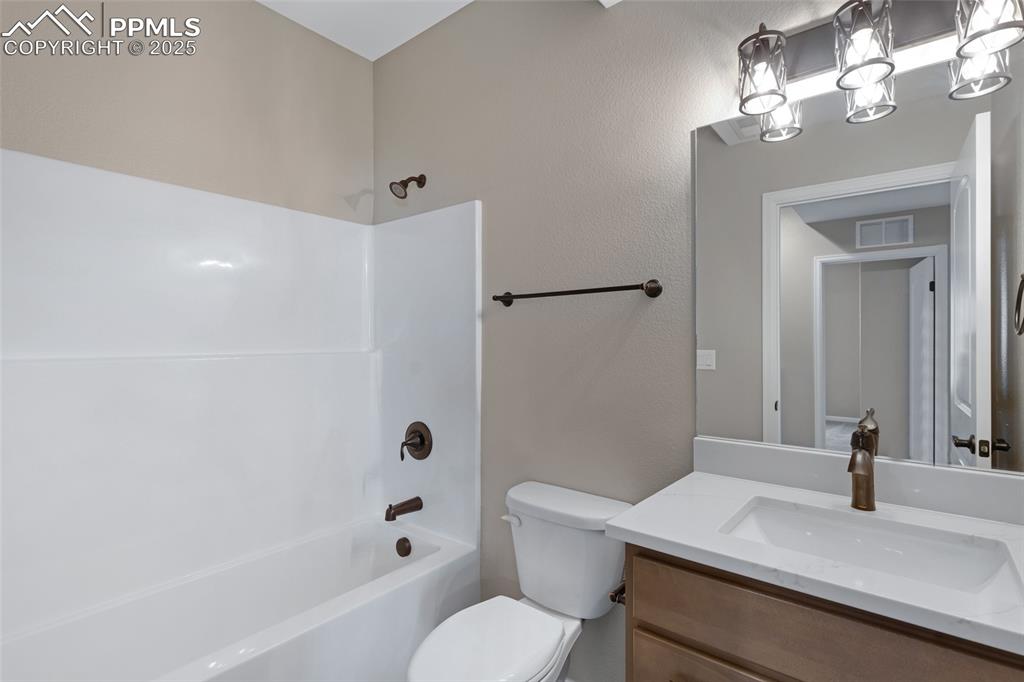 Image 25 of 41: Full bath featuring bathing tub / shower combination, vanity, and a texture