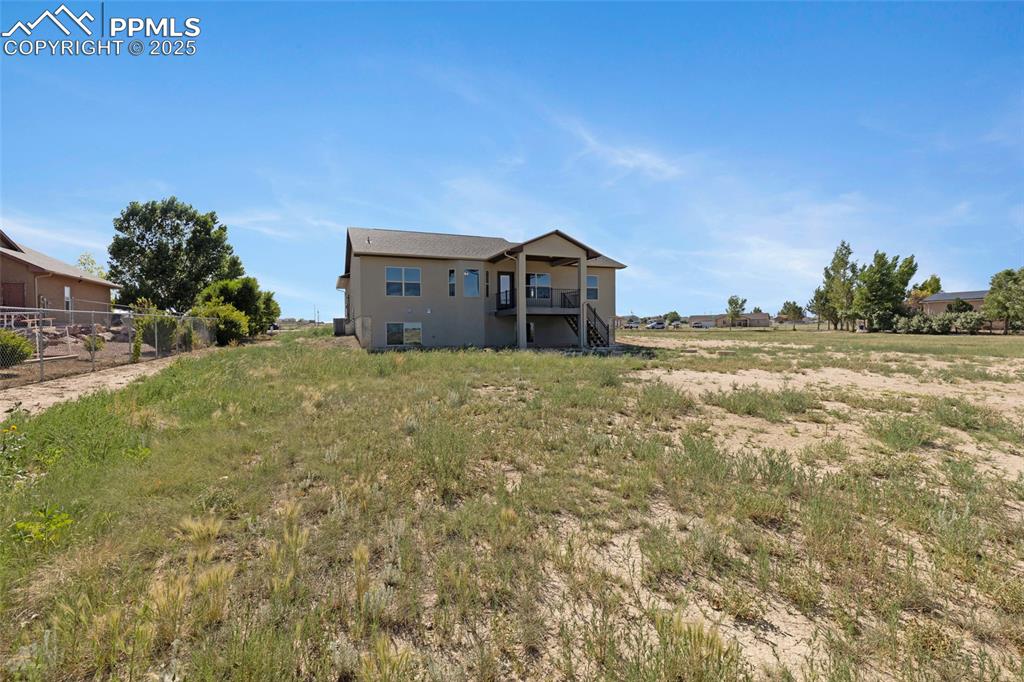 Image 28 of 41: Back of property with stucco siding
