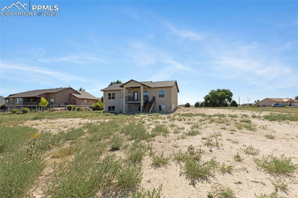 Image 30 of 41: Rear view of house with stucco siding