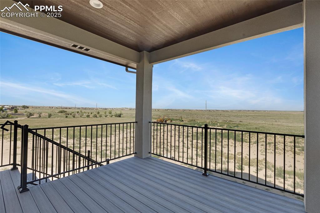 Image 31 of 41: Composite Deck with Iron railing. Greenbelt never build behind home