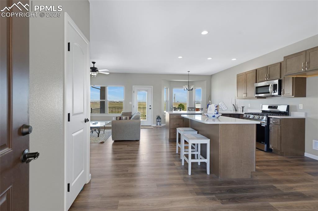 Image 5 of 41: Kitchen with appliances with stainless steel finishes, open floor plan, a b