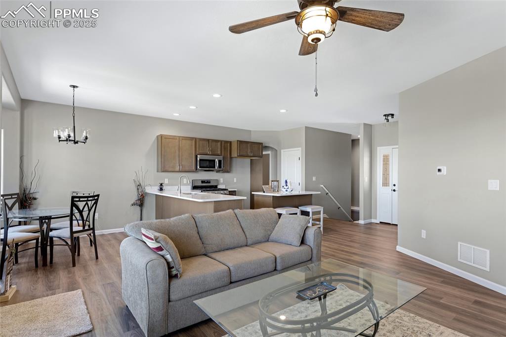 Image 7 of 41: Living area with recessed lighting, dark wood-style flooring, ceiling fan,
