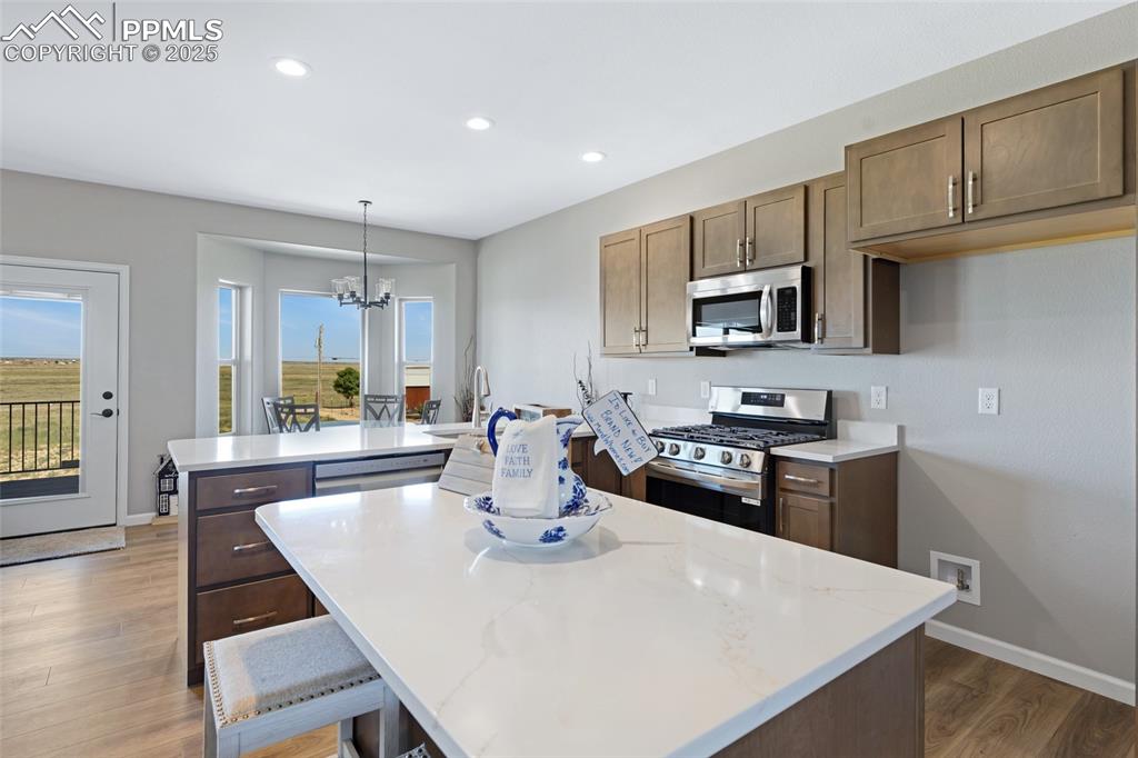 Image 8 of 41: Kitchen with stainless steel appliances, a kitchen island, recessed lightin