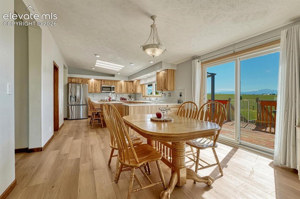 Image 13 of 50: Eat-in kitchen with walk-out
