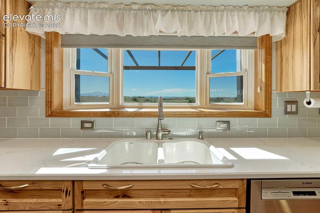 Image 14 of 50: New garden window with views of the front range mountains