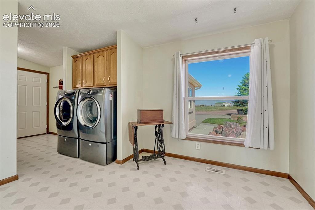 Image 18 of 50: Laundry mudroom & entry to garage