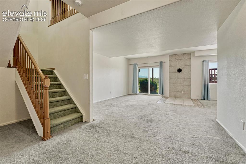 Image 25 of 50: Stairs to walkout basement and living area