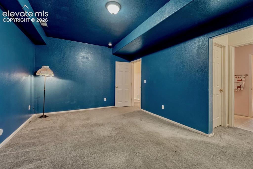 Image 35 of 50: Basement bedroom with Jack & Jill bathroom