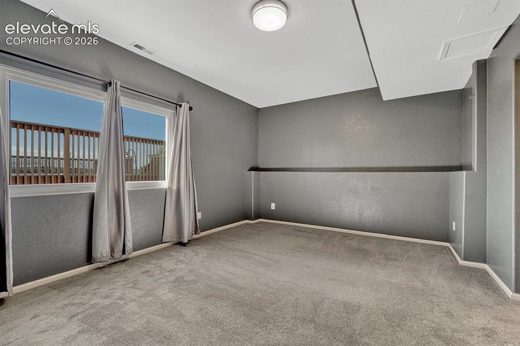 Image 37 of 50: Basement bedroom with Jack & Jill bathroom