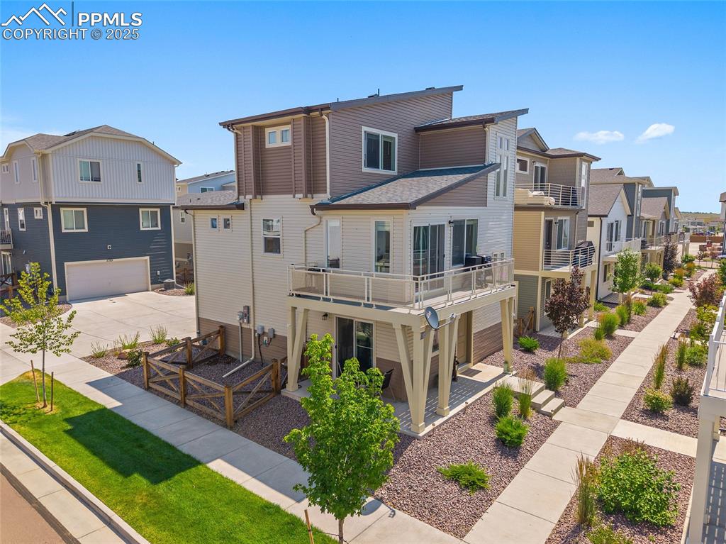 Image 2 of 38: Lower-level patio with access to the fenced in area and upper-Level deck of