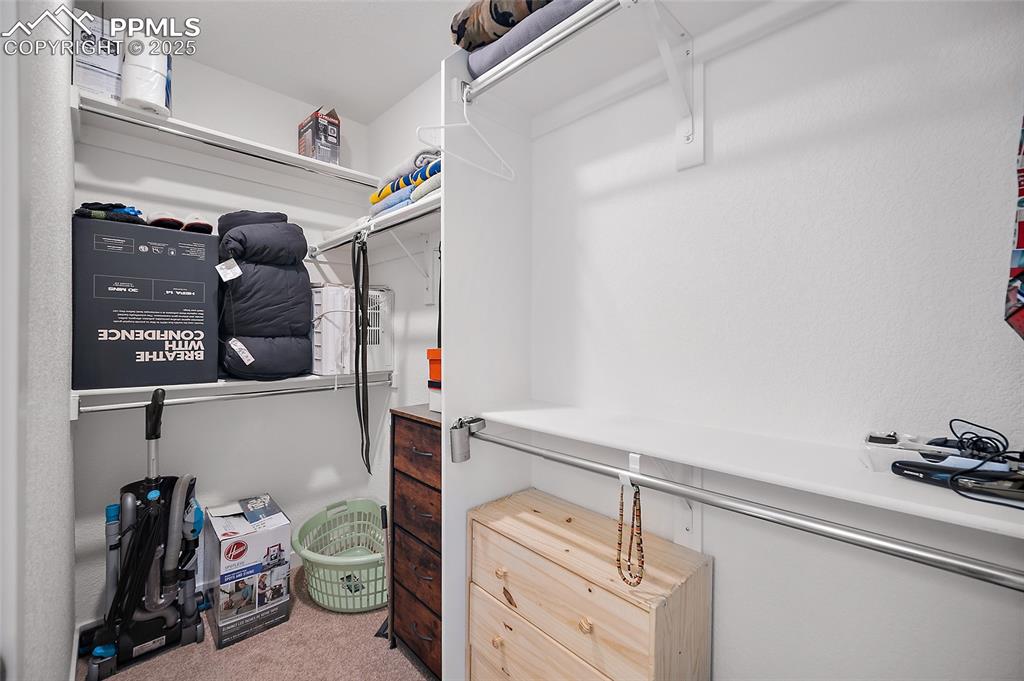 Image 21 of 38: Primary walk-in closet. 