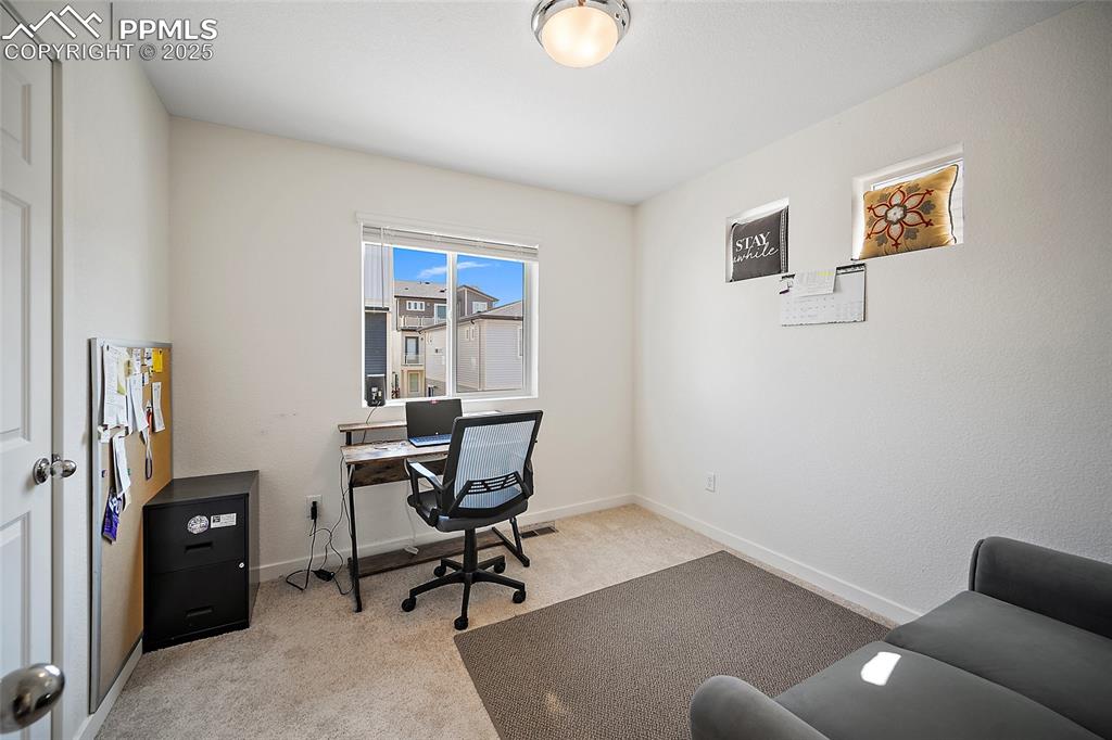 Image 24 of 38: Other upper level Bedroom being used as an office. 