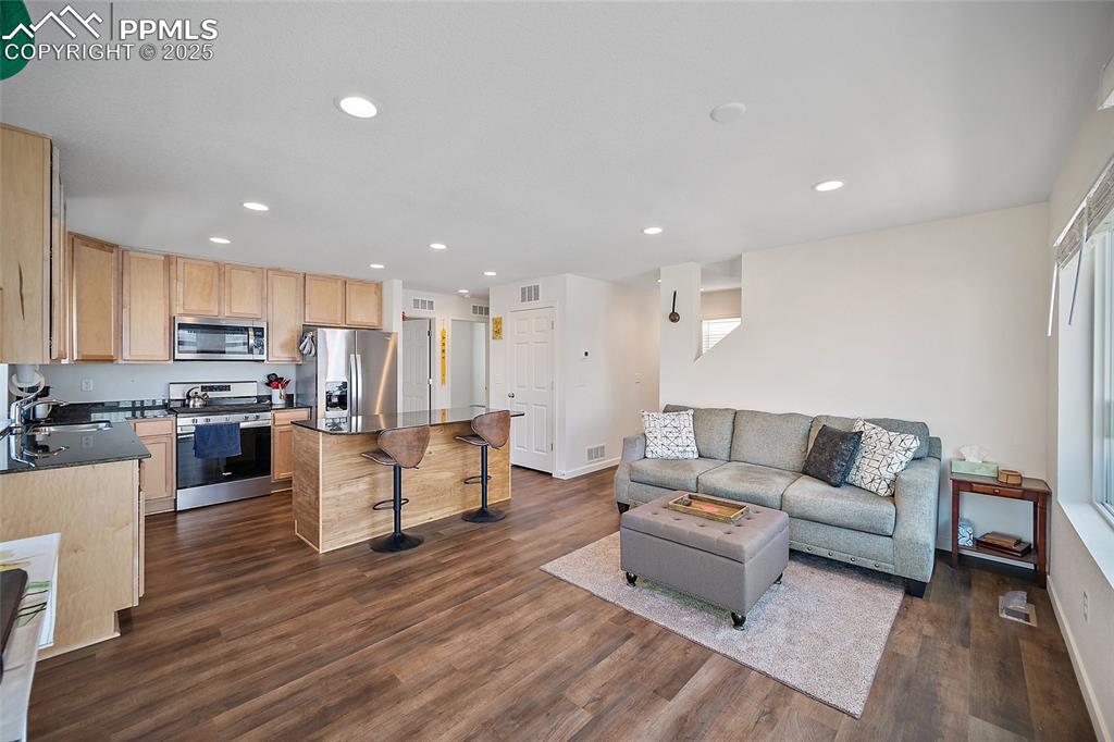 Image 9 of 38: Upper-Level Open floor plan living room and kitchen. 