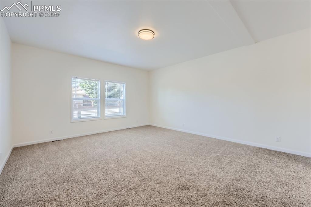 Image 10 of 16: Empty room featuring light colored carpet and baseboards