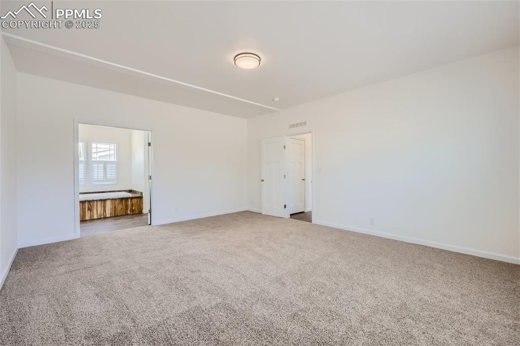 Image 12 of 16: Unfurnished bedroom with baseboards and carpet flooring