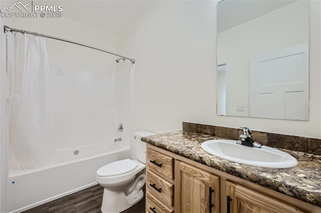 Image 14 of 16: Full bathroom with shower / bath combo with shower curtain, vanity, and dar