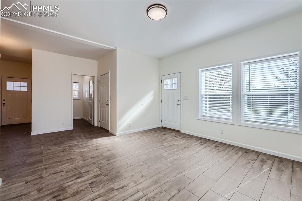 Image 5 of 16: Foyer featuring wood finished floors and baseboards