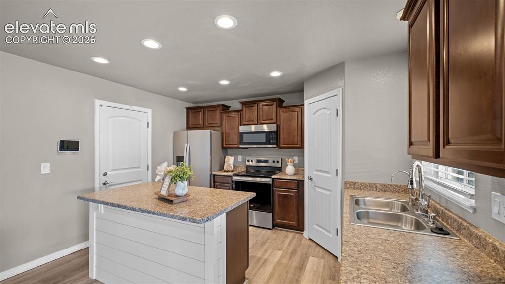 Image 15 of 43: Kitchen featuring a center island with a shiplap base, stainless steel appl