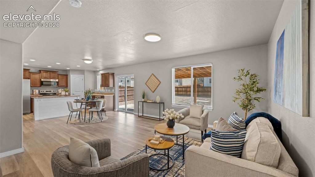 Image 17 of 43: Open-concept main living area featuring wood-finish flooring, recessed ligh