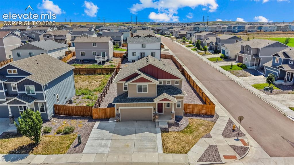 Image 34 of 43: Two-story residence featuring a two-car garage, front yard landscaping, and