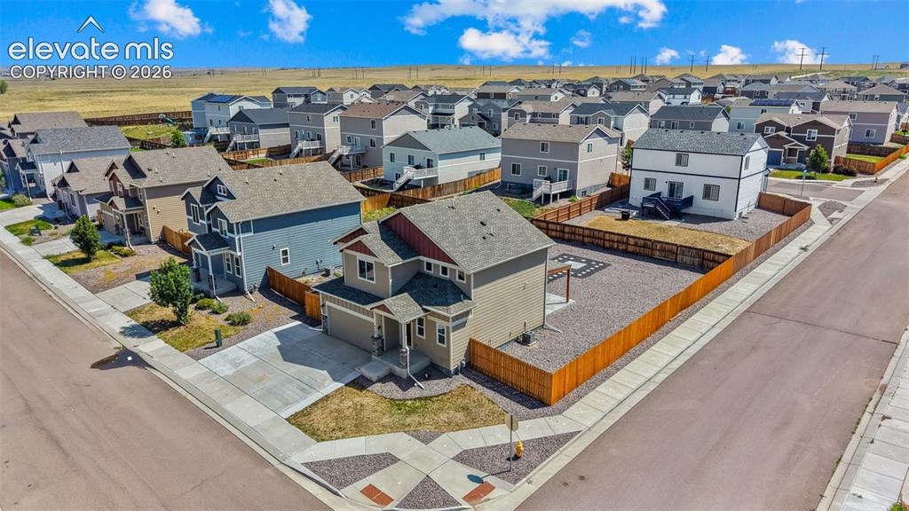 Image 36 of 43: Corner lot residence featuring a two-story design with an attached garage