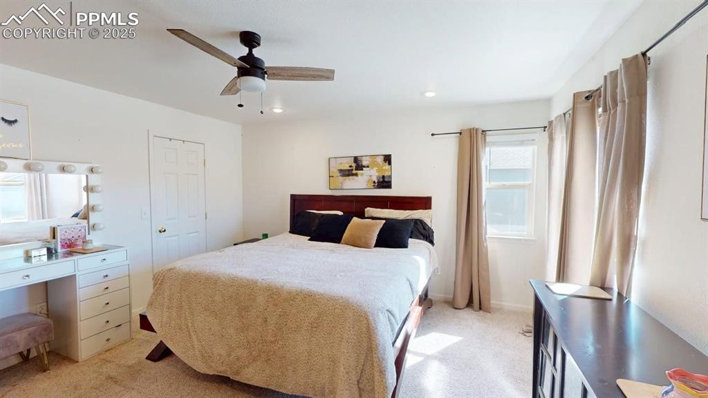 Image 11 of 14: Bedroom featuring light colored carpet, a ceiling fan, and recessed lightin