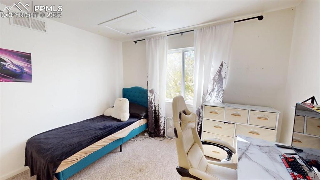 Image 13 of 14: Bedroom featuring carpet and attic access