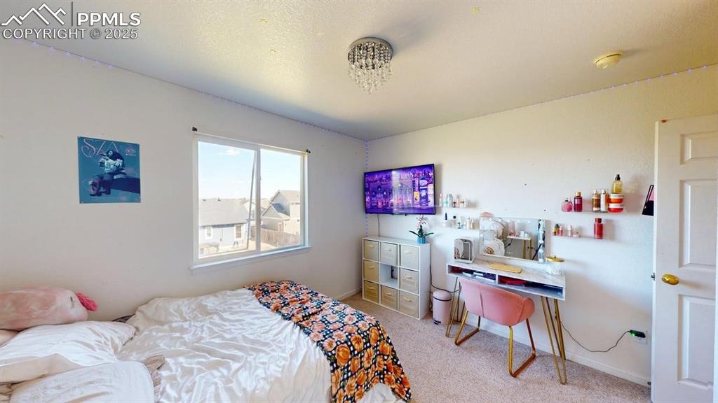 Image 14 of 14: Bedroom with light carpet and baseboards